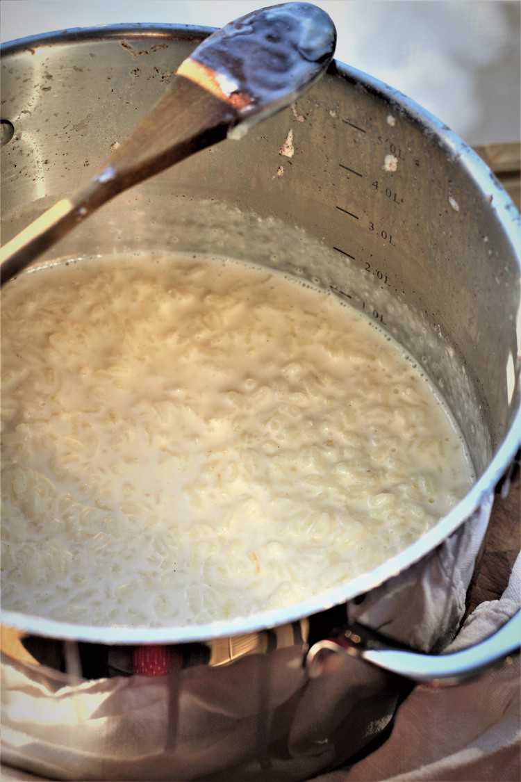 Rice and milk cooking in pot for pastiera recipe.