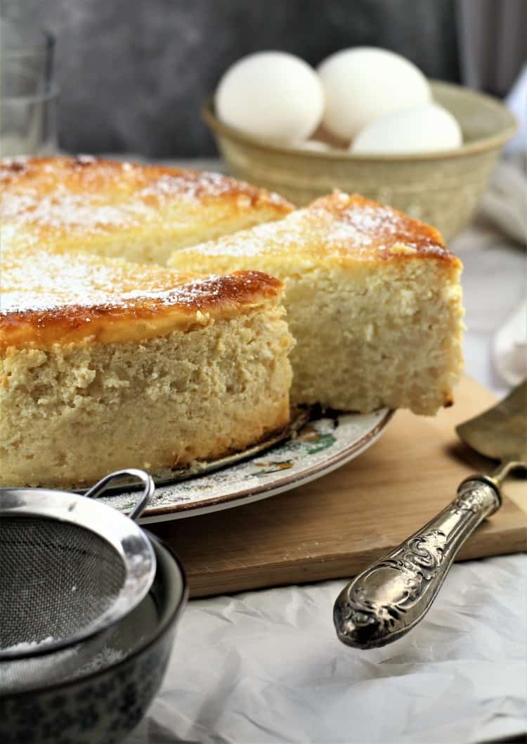 Easy No Crust Easter Pastiera with 1 wedge cut and bowl of eggs in background