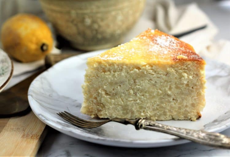 Easy No Crust Easter Pastiera Wedge of pastiera (Easter pie with rice and ricotta) on plate with fork.