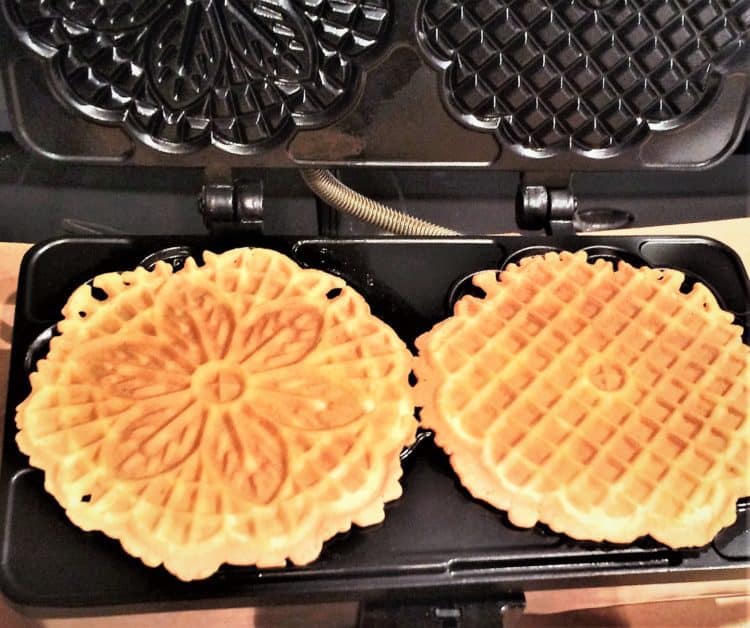 making pizzelle on a pizzelle iron for Pizzelle Cannoli with Ricotta Filling