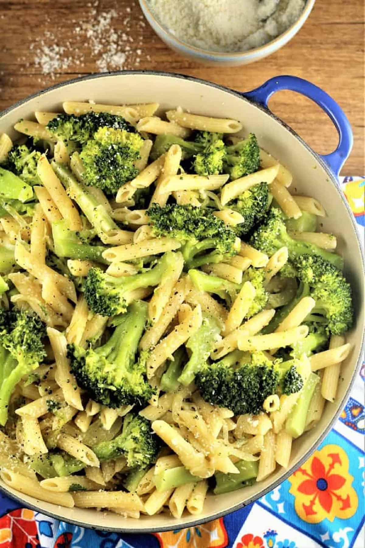 Pasta with broccoli in large skillet.