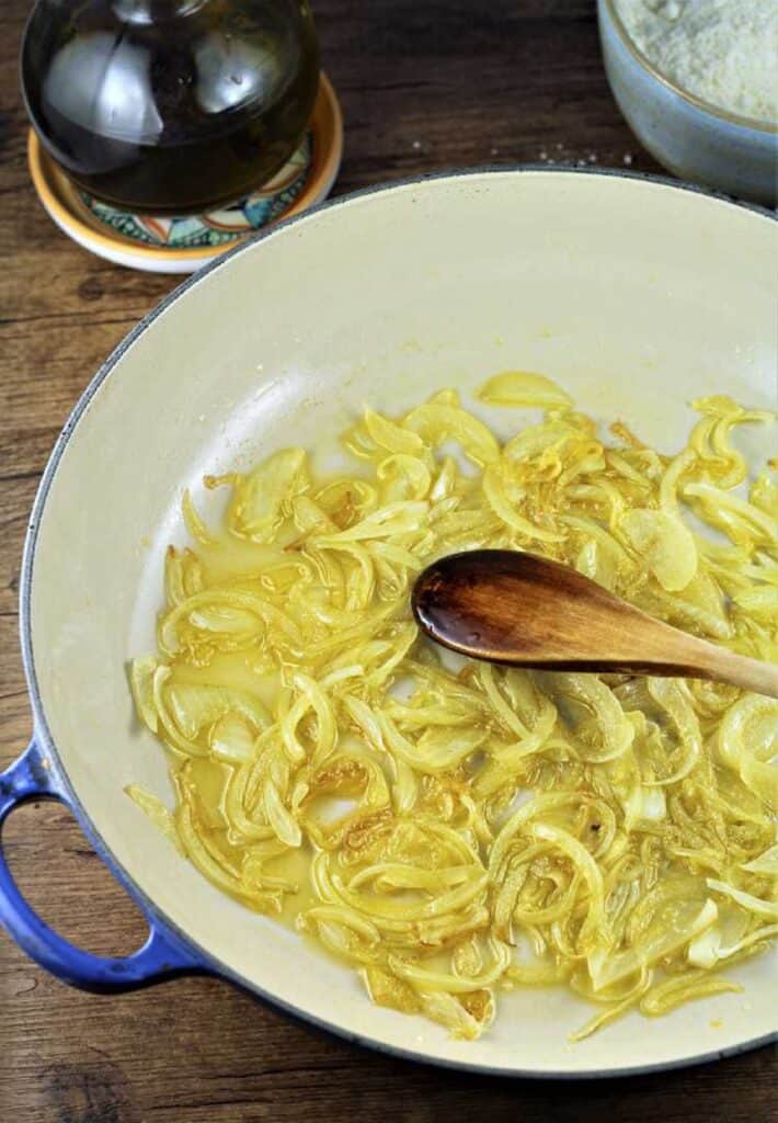 Sautéed onion in olive oil stirred in large skillet.