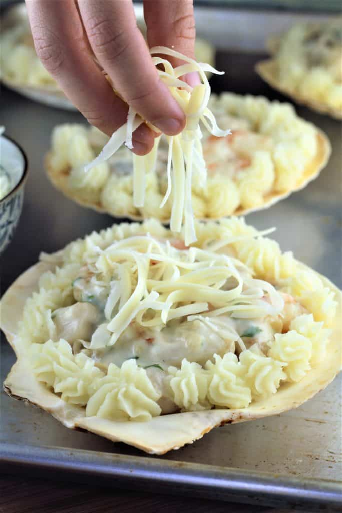 topping coquilles st-jacques with shredded mozzarella