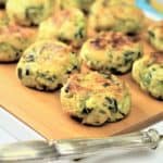 zucchini ricotta meatballs on wooden board with utensil