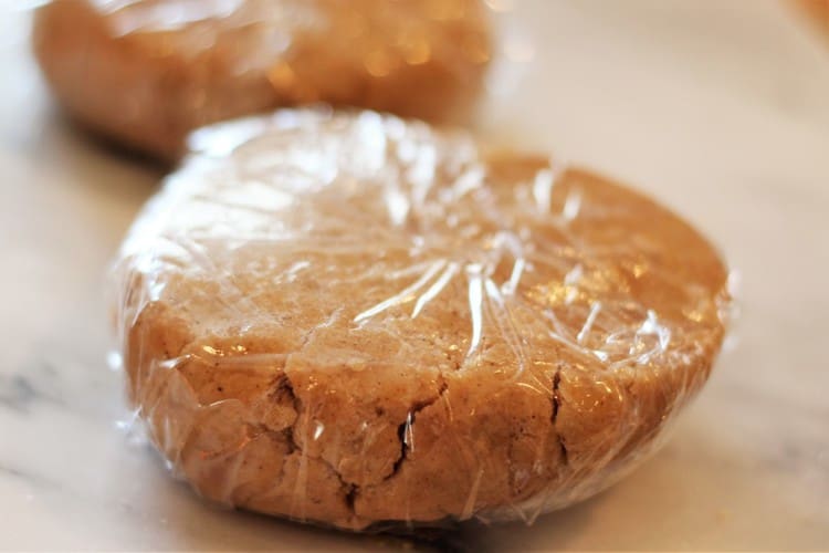 cookie dough shaped as a disk and wrapped in plastic wrap