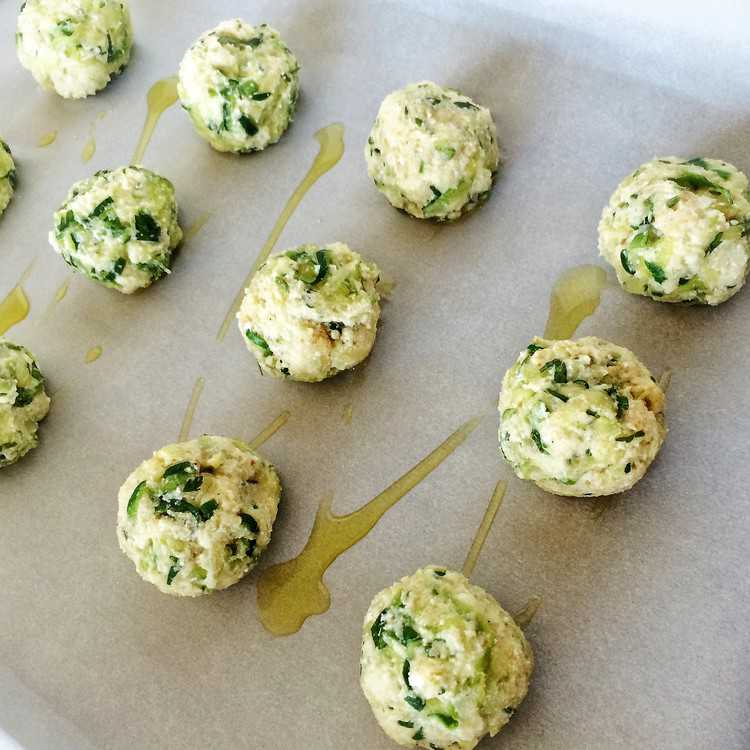 prepared spiralized zucchini ricotta meatballs on a baking sheet ready to be baked