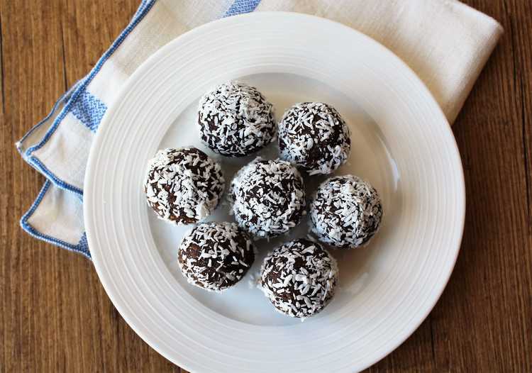overhead view of coconut covered truffles on a plate