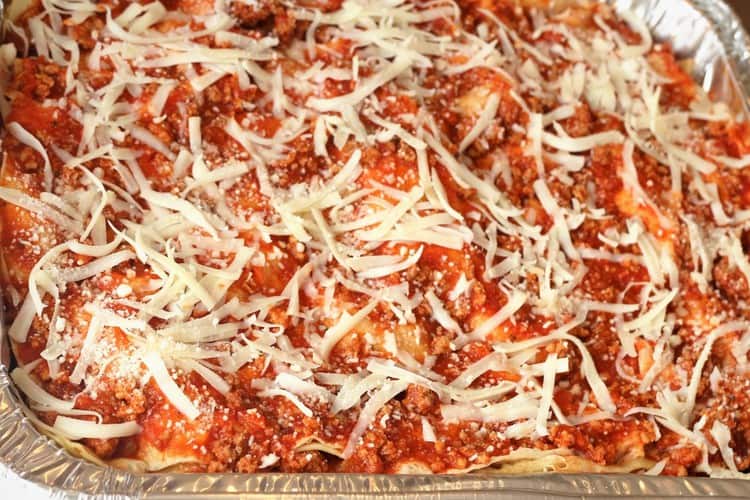 overhead view of crepe lasagna topped with shredded mozzarella