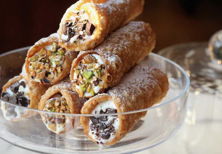 glass plate piled with sicilian cannoli