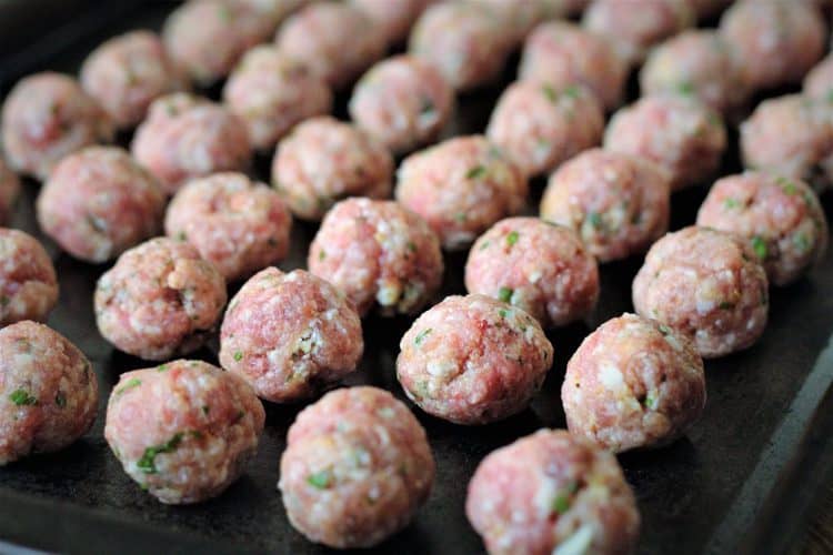 little raw meatballs on baking sheet 