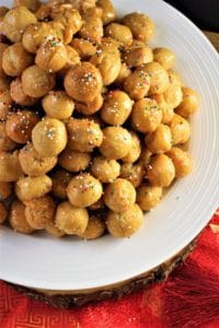 Sicilian Pignolata piled onto a white plate 