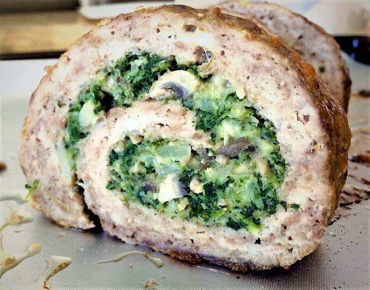 slice of spinach and mushroom filled pinwheel meatloaf