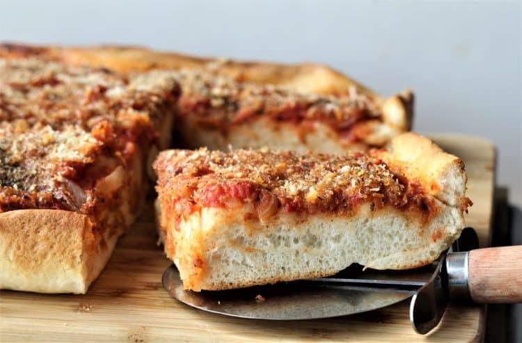 square of sfincione siciliano, sicilian style pizza just cut with pizza cutter 