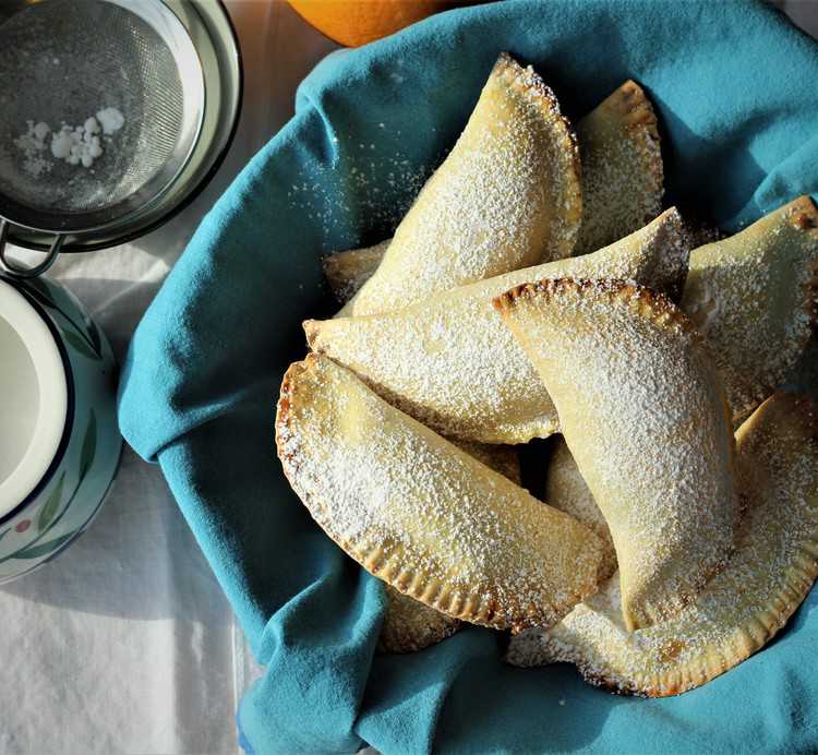 Sicilian Cassatelle with Ricotta on blue cloth covered bowl