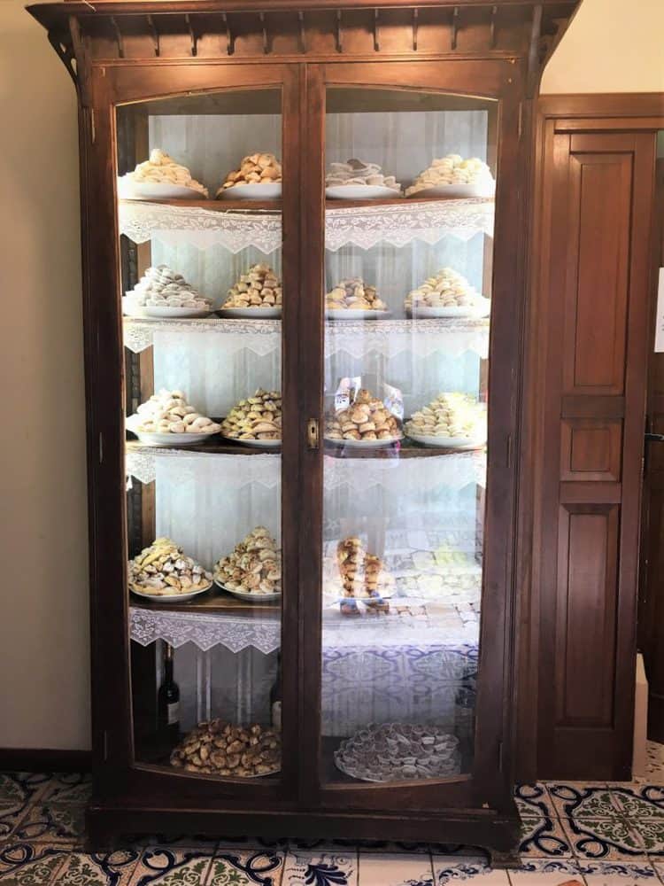 glass case filled with platters of cookies