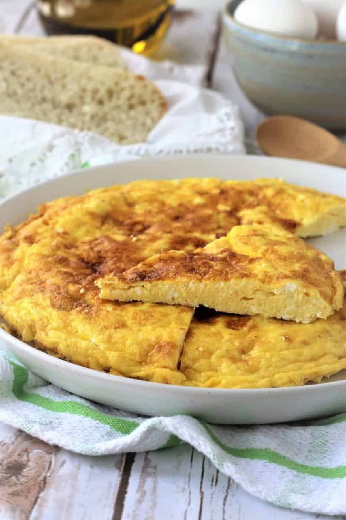 Ricotta Frittata Ricotta frittata on plate with wedge cut.