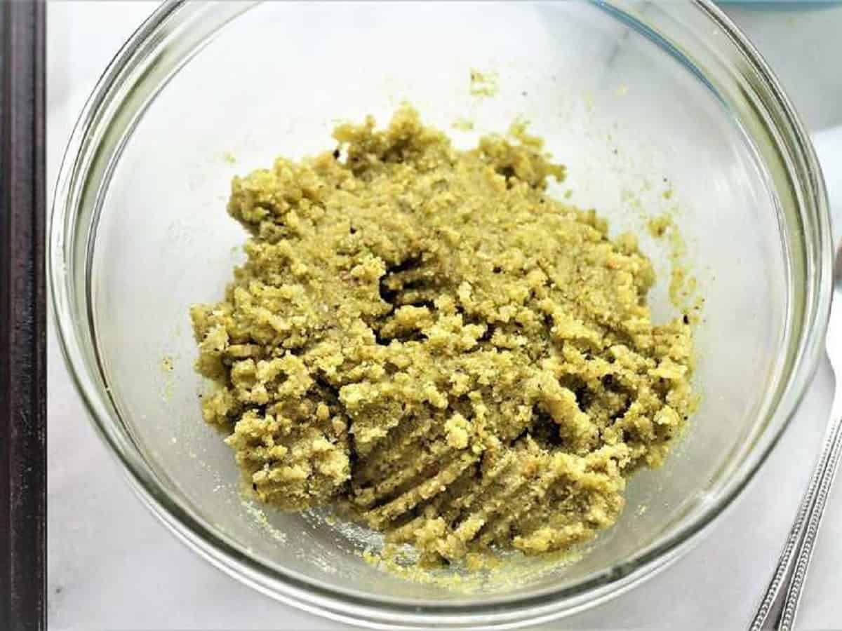 Pistachio amaretti cookie dough in glass bowl.
