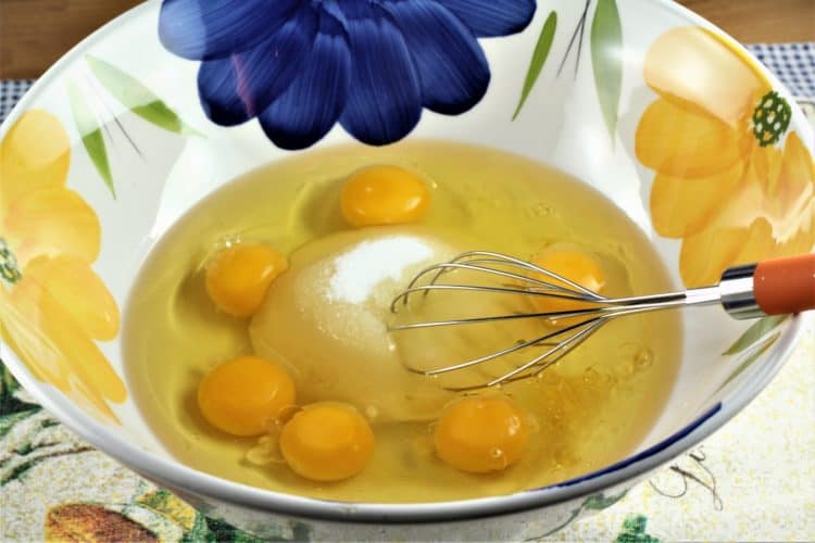 bowl with eggs and sugar and whisk