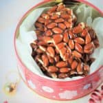 pieces of Sicilian Almond Torrone presented in a Christmas tin