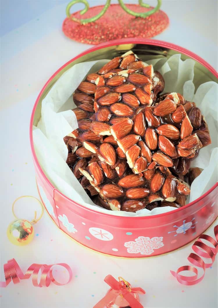 pieces of Sicilian Almond Torrone presented in a Christmas tin