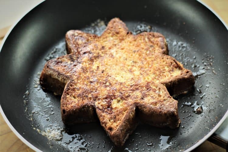 pan with slice of Pandoro french toast cooking