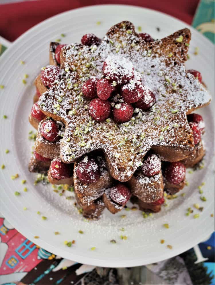 overhead photo of Pandoro french toast topped with raspberries and powdered sugar