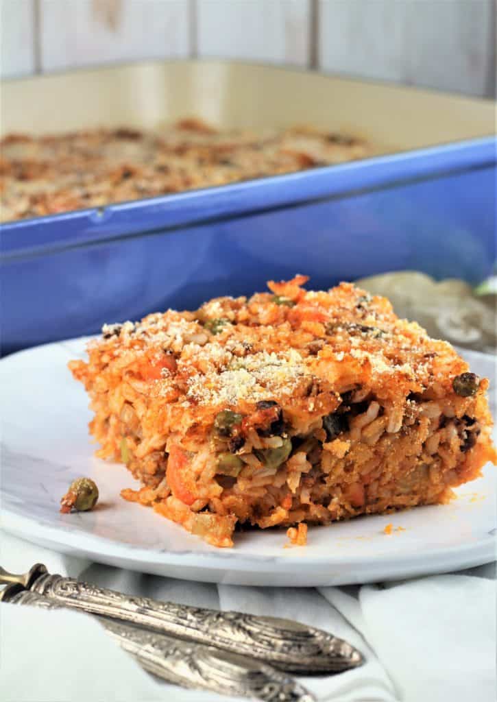 piece of Sicilian Rice Casserole served on a plate with casserole in background