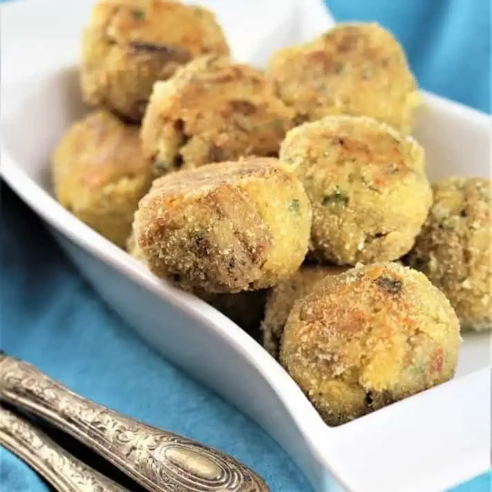 Baked eggplant meatballs in white bowl.