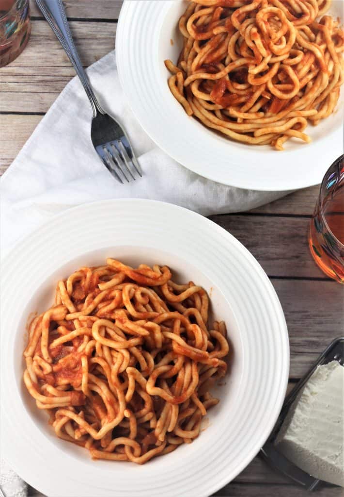 Sicilian maccheroni with tomato sauce in 2 plates