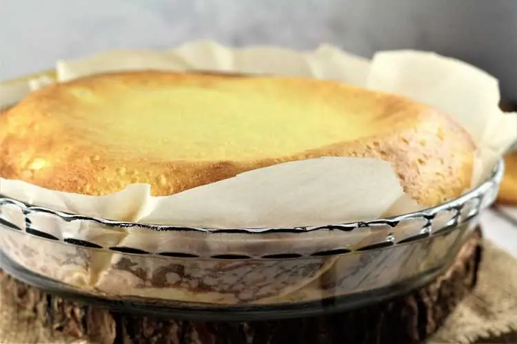 Just baked ricotta Easter calzone in parchment lined pie plate.
