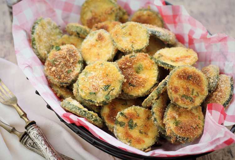 basket of Baked Zucchini Parmesan Crisps with forks on the side