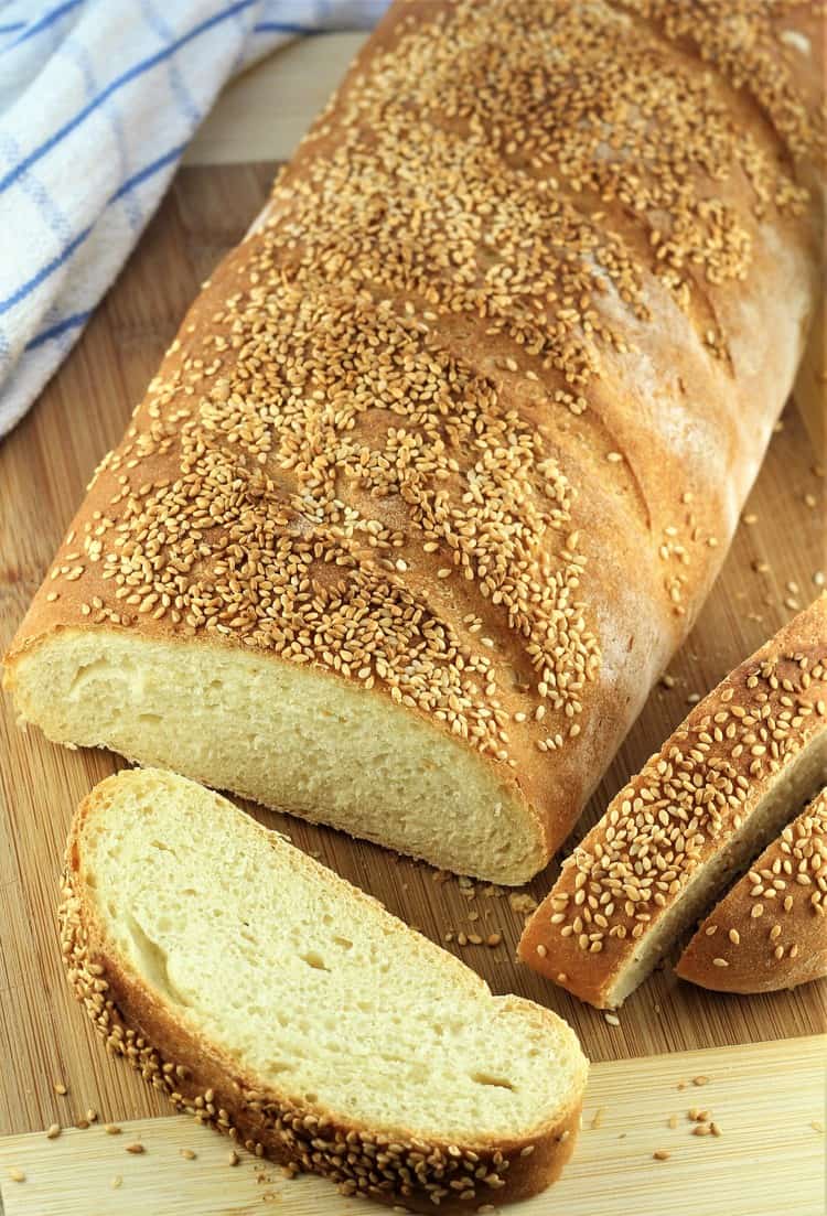 loaf of semolina bread with three slices cut off 