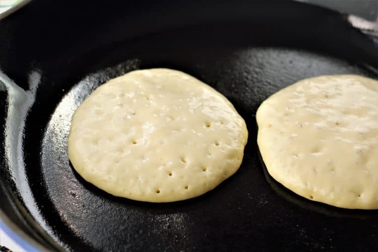 hot pan with 2 pancakes cooking 