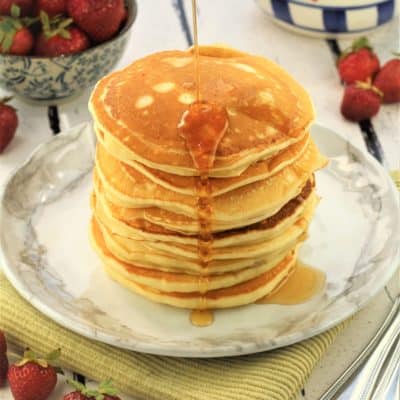 stack of yogurt pancakes with maple syrup drizzled on top