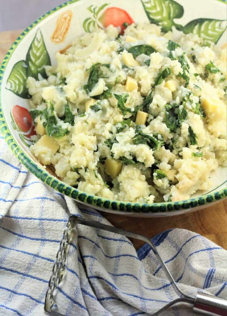 bowl with mashed potatoes, swiss chard and cubed cheese mixture