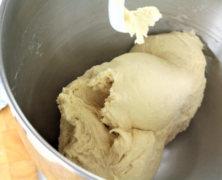 semolina bread dough in bowl of stand mixer with dough hook