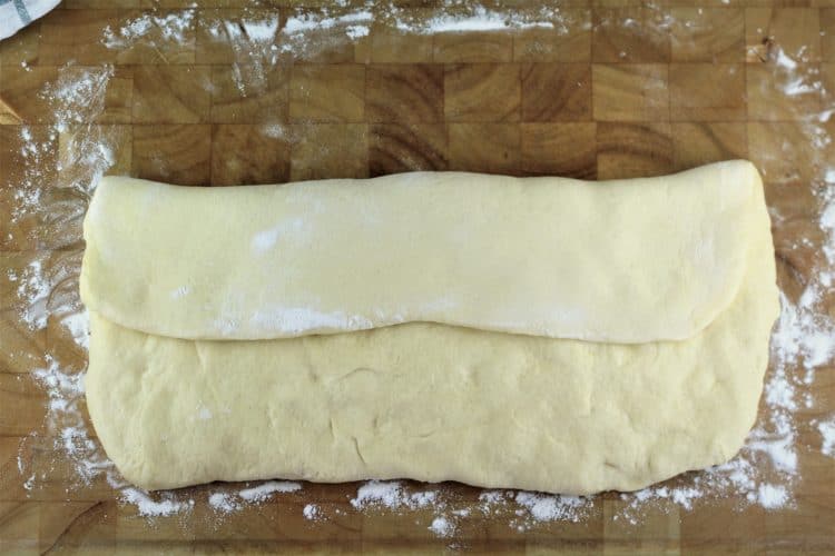 flattened semolina bread dough folded over 