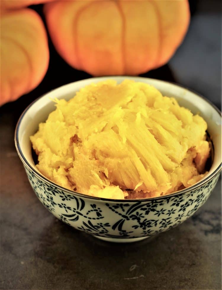 bowl with pumpkin flesh and mini pumpkins in background