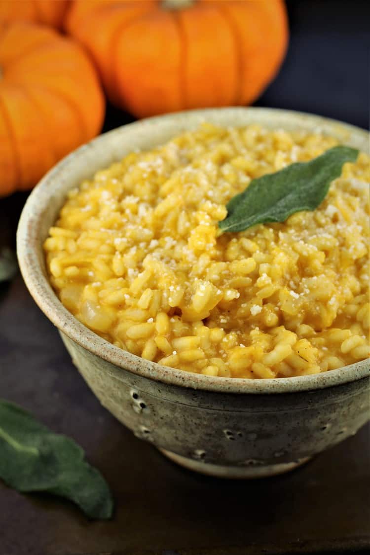 bowl of roasted pumpkin risotto with crispy sage leaf on top