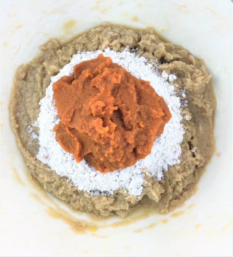 cookie batter topped with pumpkin puree for pumpkin cookies