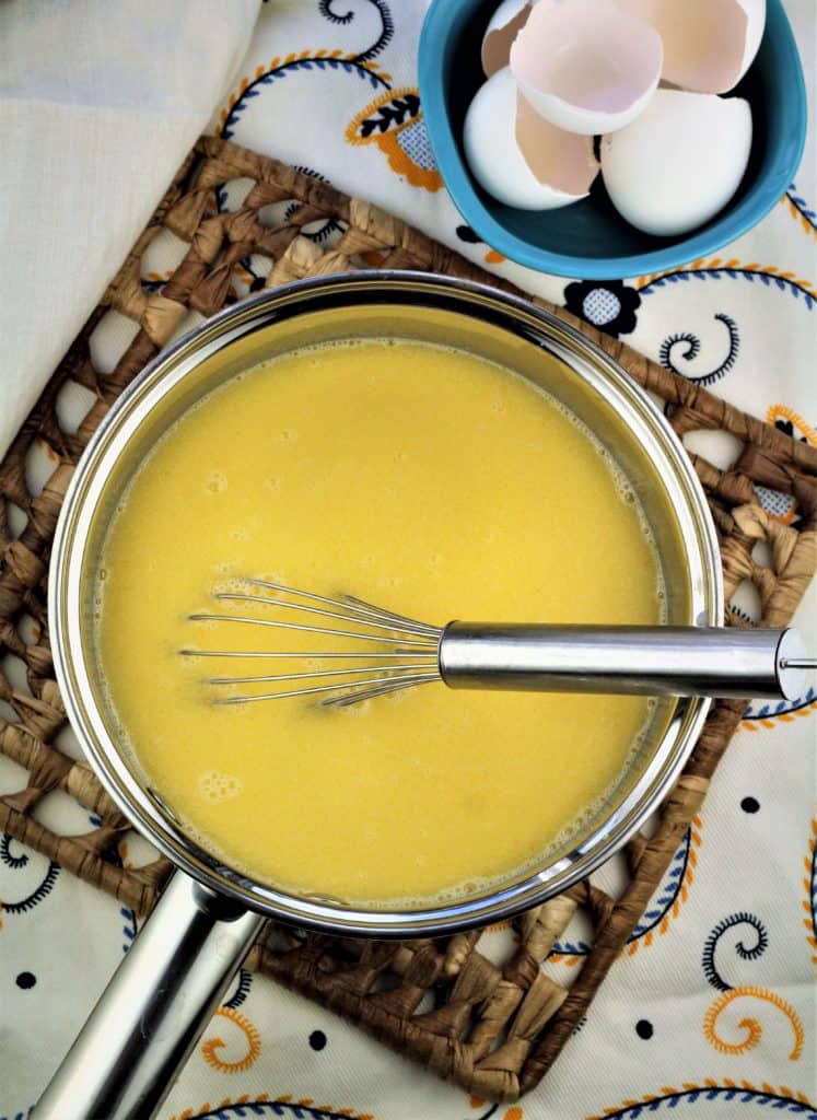 sauce pan with warm milk, butter and whisked eggs