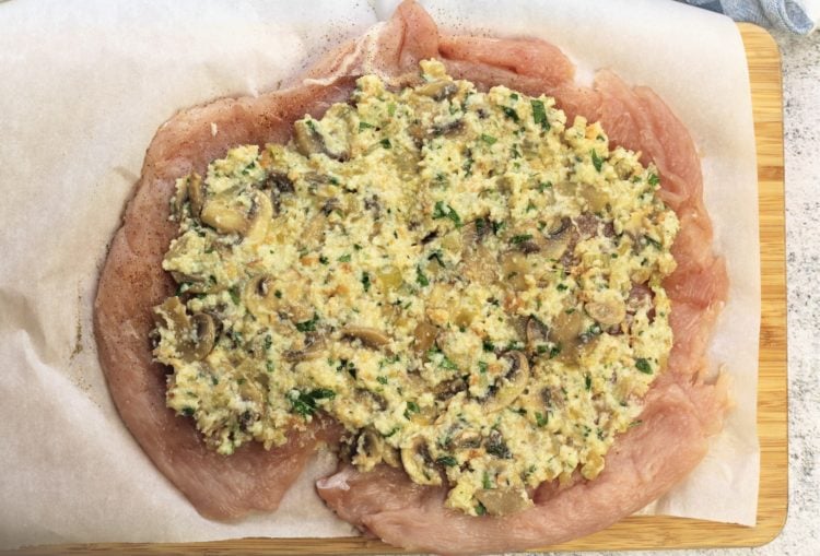 mushroom filling spread over butterflied turkey breast