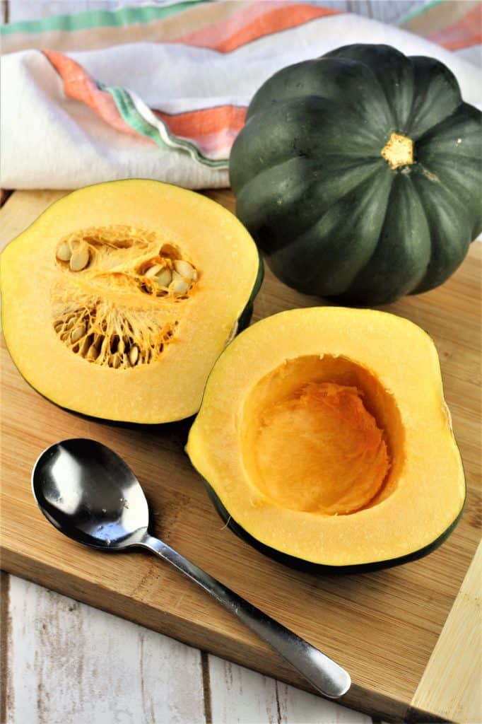 acorn squash cut in half and seeded with whole squash in background