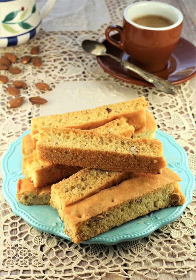 Sheet Pan Almond Biscotti on blue bowl with coffee cup