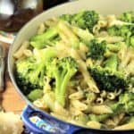 blue pan filled with pasta and broccoli