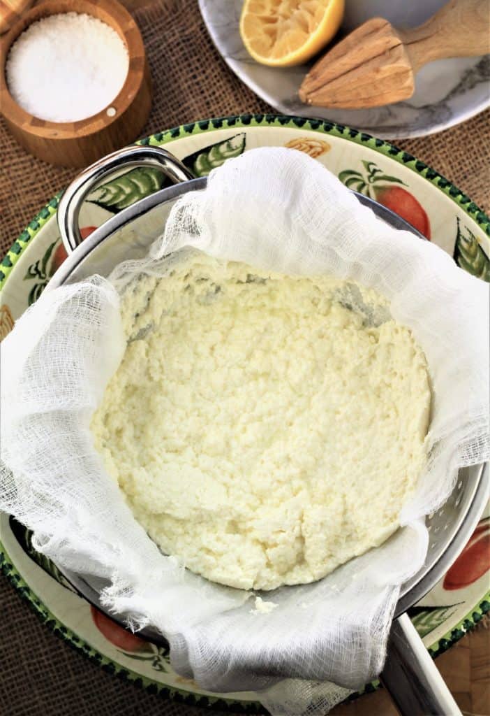 colander lined with cheese cloth with ricotta draining