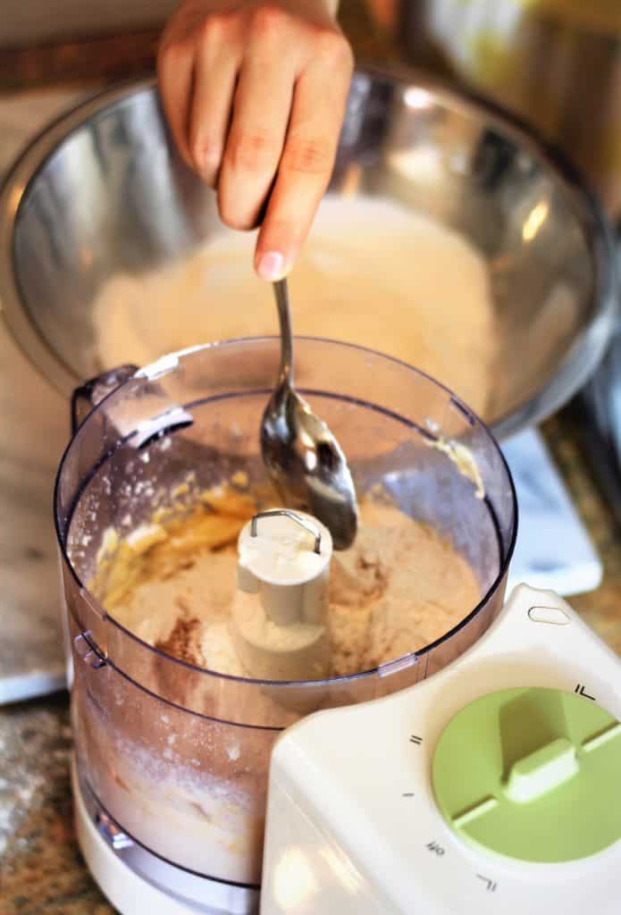 placing dry ingredients in food processor for cookies