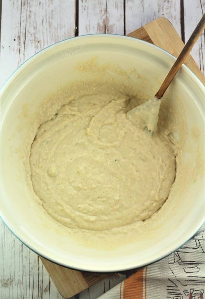 mixing bowl with batter and wooden spoon 