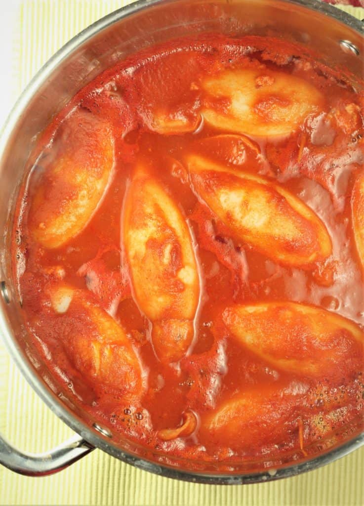 pot of tomato sauce with stuffed calamari submerged