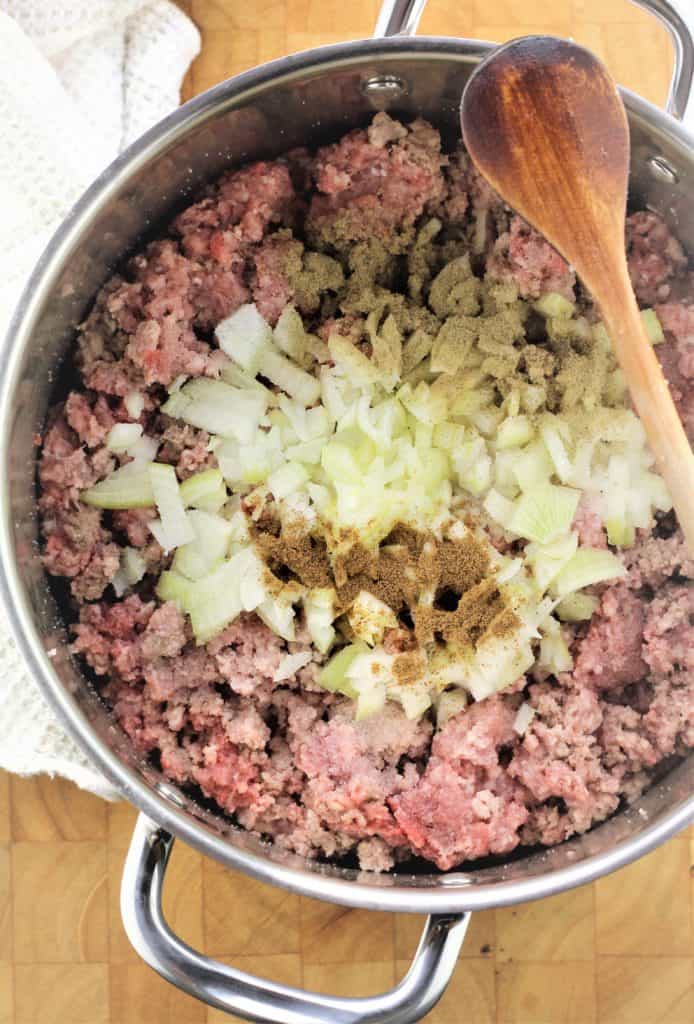 ground meat, onion and spices in a large sauce pan with woodenspoon